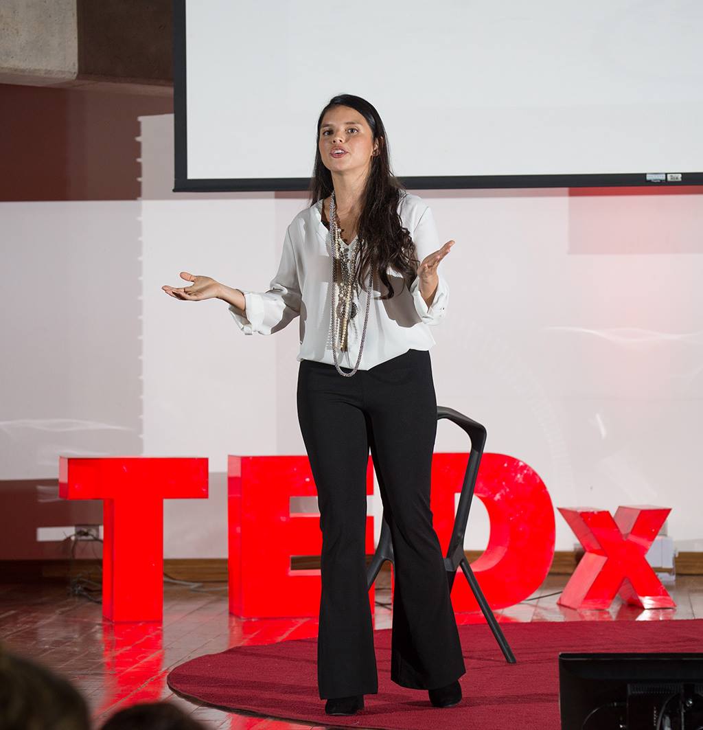 Paola hablando en un escenario TEDx